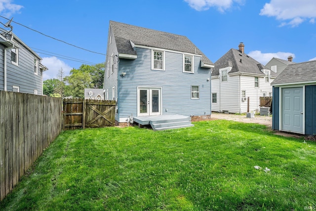 1414 Longfellow Ave, South Bend, IN 46615 - rear view of property featuring a fenced backyard, french doors, a storage unit, and a gate