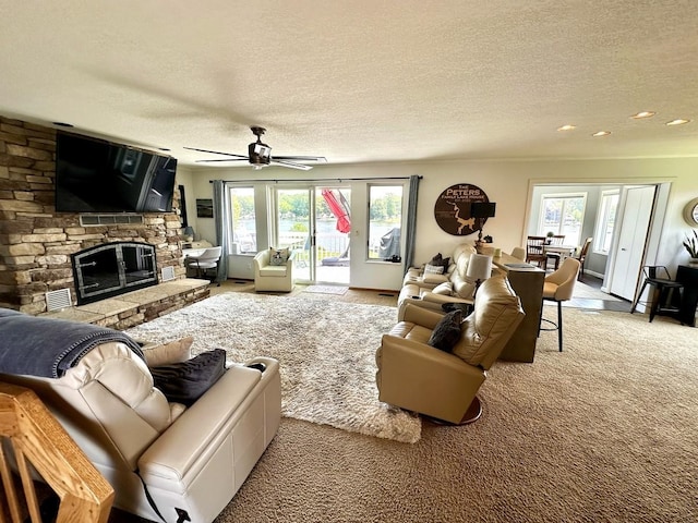 280 Ln 230 Jimmerson Lk, Angola, IN 46703 - living room featuring carpet, healthy amount of natural light, a textured ceiling, a fireplace, and ceiling fan