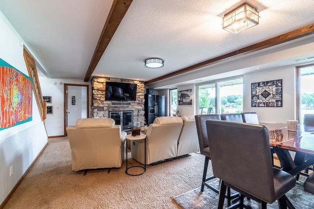 280 Ln 230 Jimmerson Lk, Angola, IN 46703 - living area with beamed ceiling, a stone fireplace, light carpet, and a textured ceiling