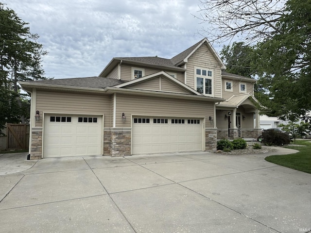 1809 N Salisbury St, West Lafayette, IN 47906 - craftsman house featuring an attached garage, stone siding, concrete driveway, and a shingled roof