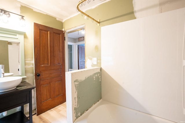 120 N Main St, Avilla, IN 46710 - bathroom with a bath, vanity, and wood finished floors