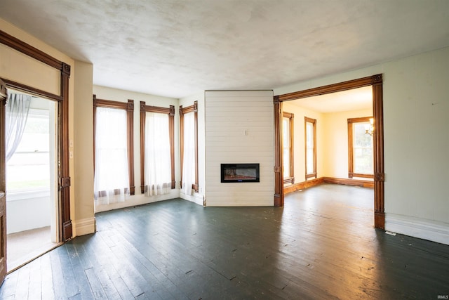120 N Main St, Avilla, IN 46710 - unfurnished living room featuring dark wood-type flooring and a fireplace