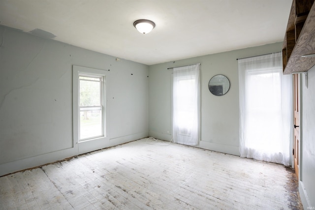 120 N Main St, Avilla, IN 46710 - empty room featuring plenty of natural light and wood finished floors