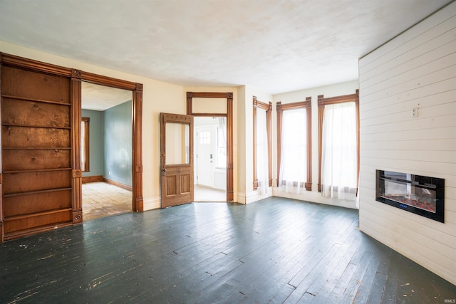 120 N Main St, Avilla, IN 46710 - unfurnished living room featuring a glass covered fireplace and hardwood / wood-style flooring