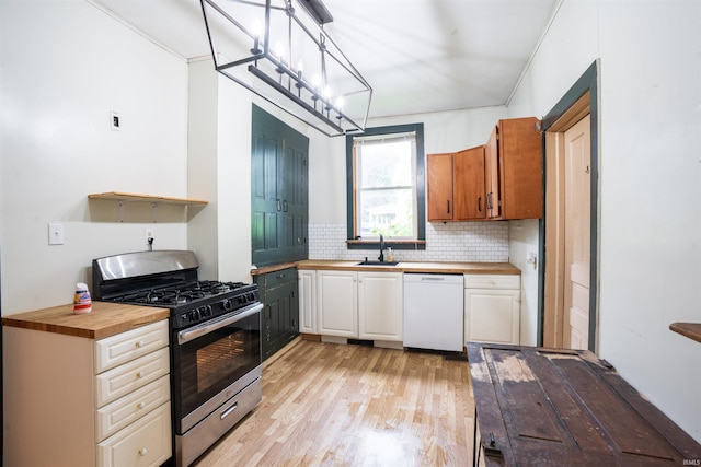 120 N Main St, Avilla, IN 46710 - kitchen featuring stainless steel gas range, dishwasher, butcher block countertops, and light wood-style flooring