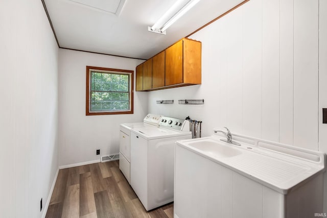 1406 W Orchard Dr, North Manchester, IN 46962 - laundry area featuring cabinet space, washer and dryer, and wood finished floors