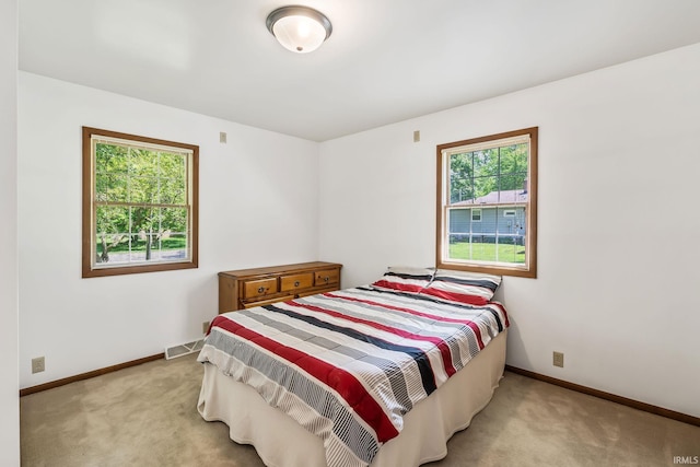 1406 W Orchard Dr, North Manchester, IN 46962 - bedroom featuring light carpet and baseboards