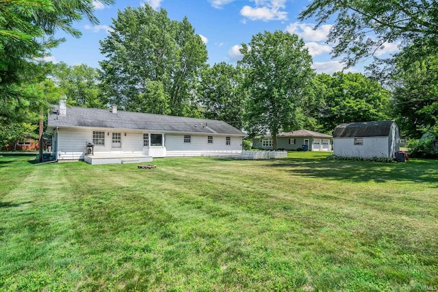 1406 W Orchard Dr, North Manchester, IN 46962 - rear view of property with a storage shed and a yard