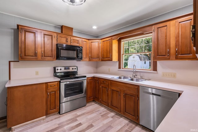 1406 W Orchard Dr, North Manchester, IN 46962 - kitchen with stainless steel appliances, light countertops, brown cabinets, and crown molding