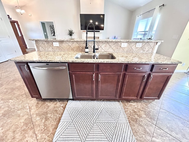 3607 Regatta Dr, Lafayette, IN 47909 - kitchen featuring stainless steel dishwasher, a center island with sink, backsplash, light stone counters, and light tile patterned floors