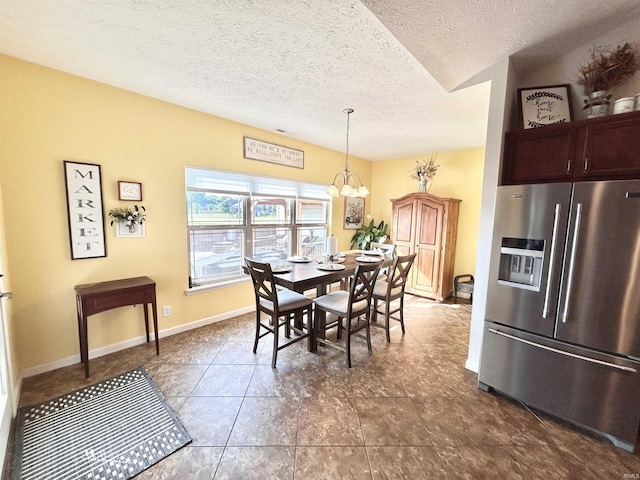 3607 Regatta Dr, Lafayette, IN 47909 - dining area with a textured ceiling, a chandelier, and dark tile patterned flooring