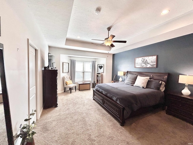 3607 Regatta Dr, Lafayette, IN 47909 - bedroom with a textured ceiling, light carpet, a raised ceiling, and a ceiling fan