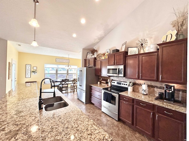 3607 Regatta Dr, Lafayette, IN 47909 - kitchen with appliances with stainless steel finishes, decorative backsplash, vaulted ceiling, decorative light fixtures, and light stone countertops