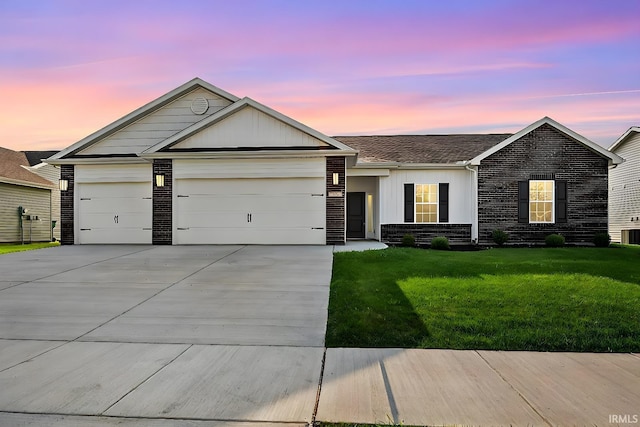 323 Haddington Ln, Lafayette, IN 47905 - single story home featuring concrete driveway, a garage, a yard, brick siding, and board and batten siding