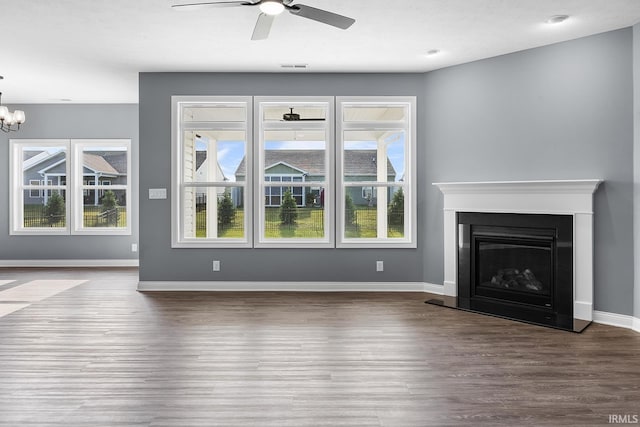 323 Haddington Ln, Lafayette, IN 47905 - unfurnished living room featuring wood finished floors, ceiling fan, a chandelier, and a fireplace with raised hearth