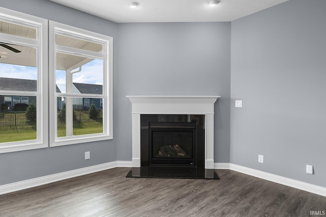 323 Haddington Ln, Lafayette, IN 47905 - detailed view of wood finished floors, a fireplace with raised hearth, and a ceiling fan