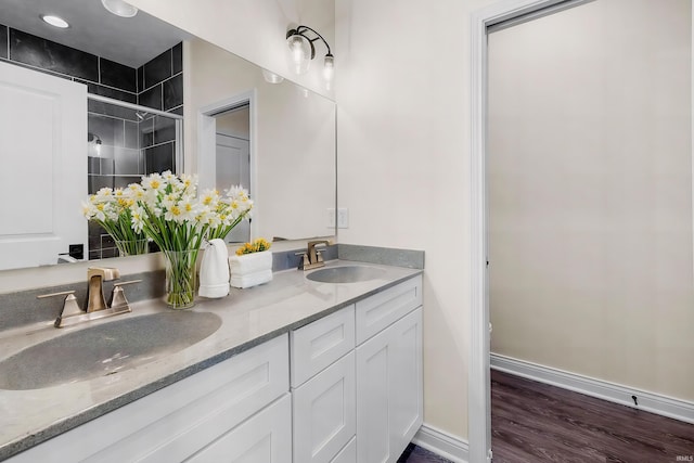 323 Haddington Ln, Lafayette, IN 47905 - full bathroom with double vanity, an enclosed shower, and wood finished floors