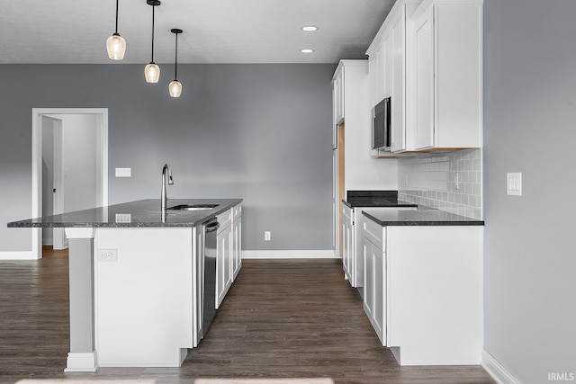 323 Haddington Ln, Lafayette, IN 47905 - kitchen with stainless steel appliances, dark wood-style floors, white cabinetry, an island with sink, and backsplash
