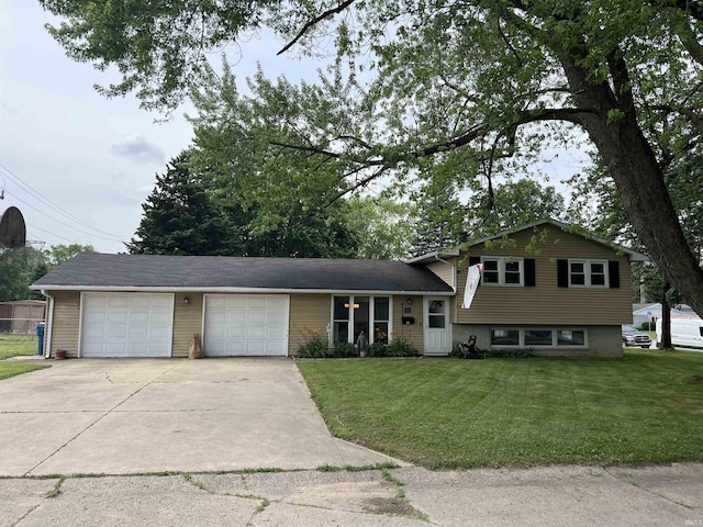406 Twillo Run Dr, New Haven, IN 46774 - split level home with concrete driveway, a front lawn, and an attached garage