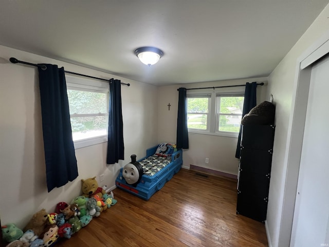 406 Twillo Run Dr, New Haven, IN 46774 - bedroom featuring multiple windows and wood finished floors