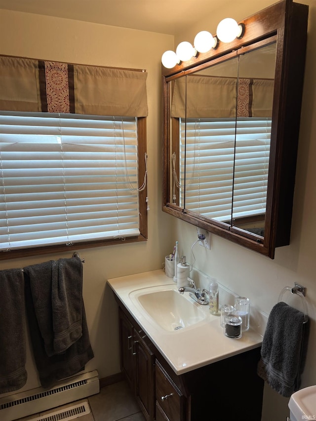 406 Twillo Run Dr, New Haven, IN 46774 - bathroom featuring vanity, a baseboard heating unit, tile patterned floors, and plenty of natural light