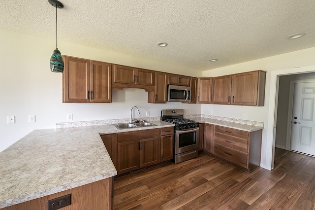 5205 Pigeon Creek Ct, Fort Wayne, IN 46825 - kitchen featuring appliances with stainless steel finishes, a textured ceiling, dark wood-type flooring, light countertops, and decorative light fixtures