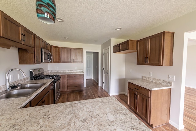 5205 Pigeon Creek Ct, Fort Wayne, IN 46825 - kitchen with stainless steel appliances, dark wood-type flooring, light countertops, a textured ceiling, and recessed lighting