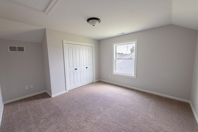 5205 Pigeon Creek Ct, Fort Wayne, IN 46825 - unfurnished bedroom featuring lofted ceiling, a closet, and carpet floors