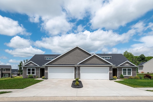 5205 Pigeon Creek Ct, Fort Wayne, IN 46825 - craftsman-style home featuring an attached garage, brick siding, a front lawn, and driveway