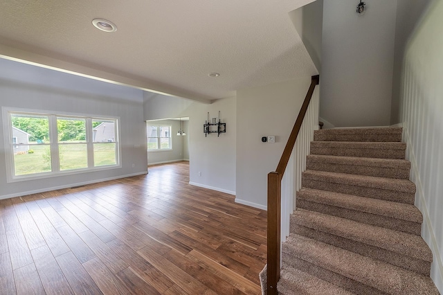5205 Pigeon Creek Ct, Fort Wayne, IN 46825 - stairway featuring wood finished floors, a textured ceiling, and recessed lighting