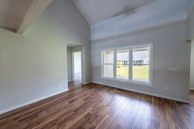 5205 Pigeon Creek Ct, Fort Wayne, IN 46825 - spare room with high vaulted ceiling and dark wood-style floors