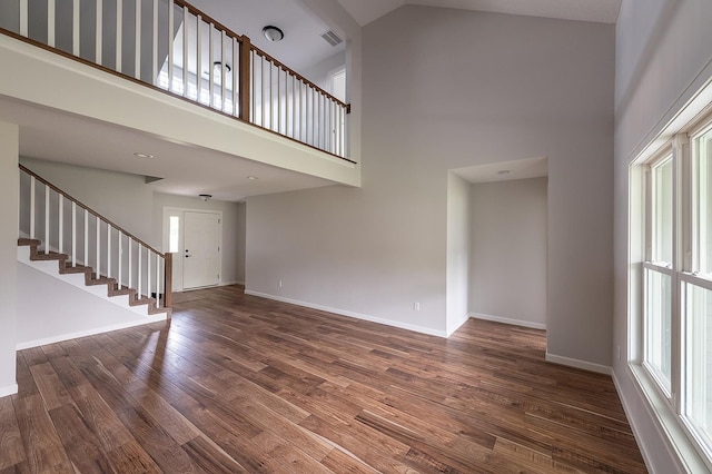 5205 Pigeon Creek Ct, Fort Wayne, IN 46825 - unfurnished living room featuring a high ceiling, plenty of natural light, stairs, and wood finished floors