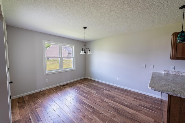 5205 Pigeon Creek Ct, Fort Wayne, IN 46825 - unfurnished dining area featuring dark wood-type flooring and a textured ceiling