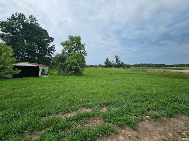 407 N Ray St, Fremont, IN 46737 - view of yard with an outdoor structure, a view of countryside, and an outbuilding