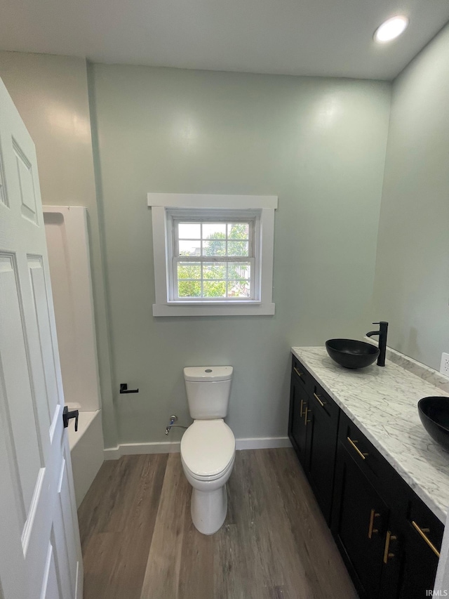 312 E 2nd St, Bicknell, IN 47512 - bathroom with wood finished floors and double vanity