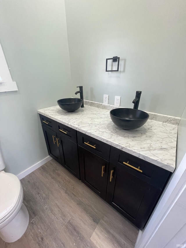 312 E 2nd St, Bicknell, IN 47512 - bathroom featuring wood finished floors and double vanity