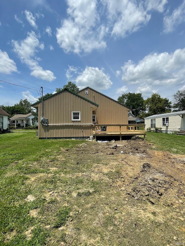 312 E 2nd St, Bicknell, IN 47512 - view of side of home featuring a deck and a lawn