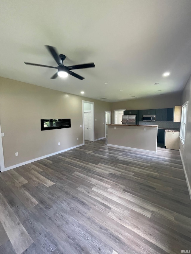 312 E 2nd St, Bicknell, IN 47512 - unfurnished living room featuring a ceiling fan, dark wood finished floors, and recessed lighting