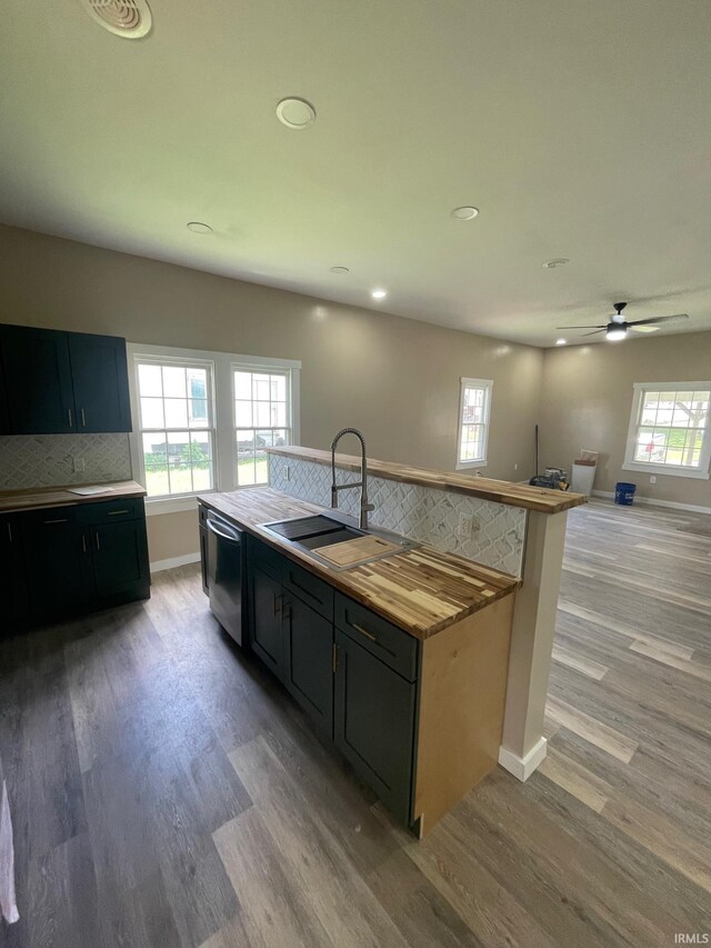 312 E 2nd St, Bicknell, IN 47512 - kitchen with light wood-style floors, tasteful backsplash, recessed lighting, dishwasher, and dark cabinets
