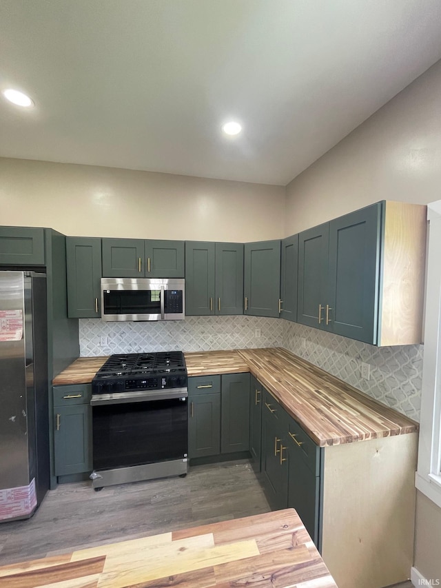 312 E 2nd St, Bicknell, IN 47512 - kitchen featuring appliances with stainless steel finishes, wooden counters, light wood-type flooring, decorative backsplash, and recessed lighting
