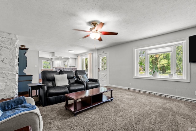 51881 Currant Rd, Granger, IN 46530 - living room with a baseboard heating unit, ceiling fan, a textured ceiling, and carpet flooring