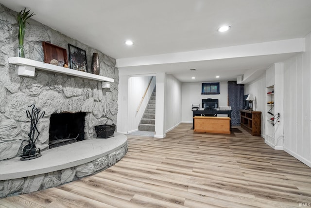 51881 Currant Rd, Granger, IN 46530 - living room with wood finished floors, a stone fireplace, stairway, and recessed lighting