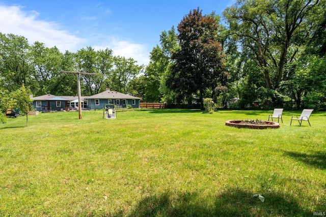 51881 Currant Rd, Granger, IN 46530 - view of yard with a fire pit and view of wooded area