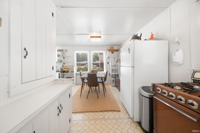 387 Ems T26 Ln, Leesburg, IN 46538 - kitchen featuring gas stove, freestanding refrigerator, white cabinetry, light countertops, and light floors