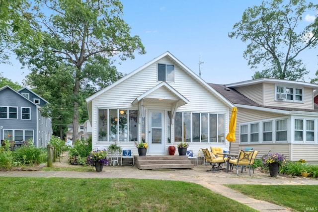 387 Ems T26 Ln, Leesburg, IN 46538 - rear view of house featuring a patio area, a lawn, and a sunroom