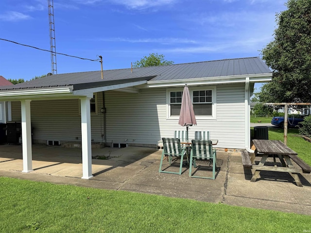 305 S Grove St, Odon, IN 47562 - rear view of house with a metal roof and a patio area