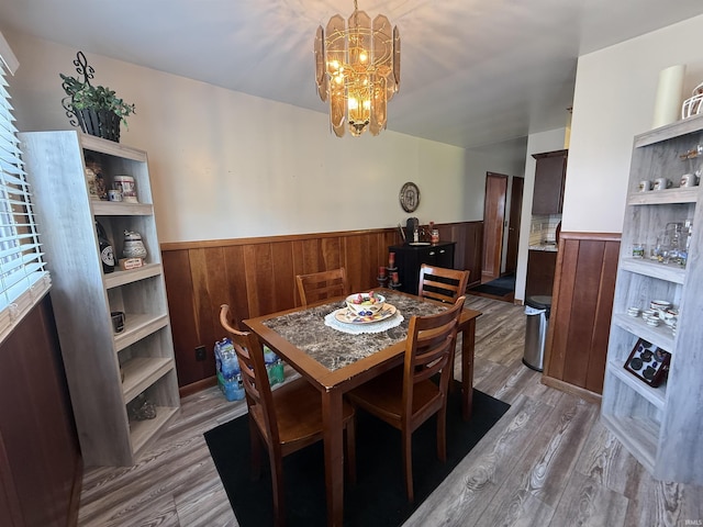 305 S Grove St, Odon, IN 47562 - dining room featuring a wainscoted wall, a chandelier, wood finished floors, and wooden walls