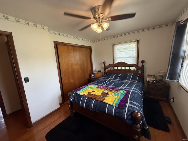 305 S Grove St, Odon, IN 47562 - bedroom with wood finished floors, a closet, and a ceiling fan