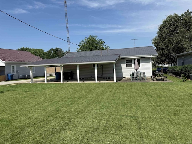 305 S Grove St, Odon, IN 47562 - rear view of property with a patio area, a lawn, and a metal roof