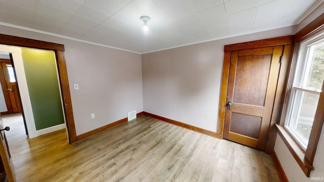 1219 Oakland St, Fort Wayne, IN 46808 - spare room featuring crown molding and light wood-style flooring
